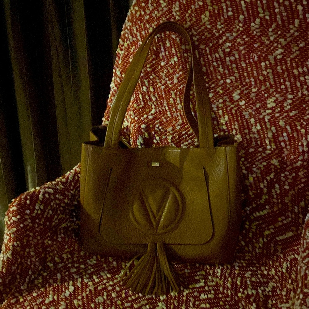 Valentino leather handbag. Front compartment cellphone access.